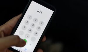 Hand dialing 911 on mobile phone