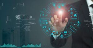 A man's hand touching a digital holographic dashboard with data